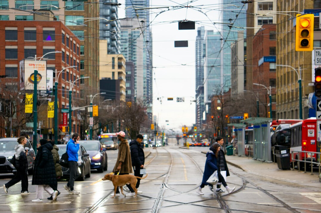 Busy downtown Toronto street with pedestrians and streetcars